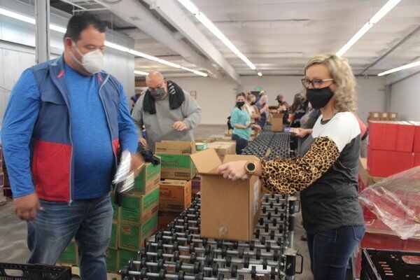 God's Pantry, volunteers pack 950 baskets for 'Sharing Thanksgiving' program